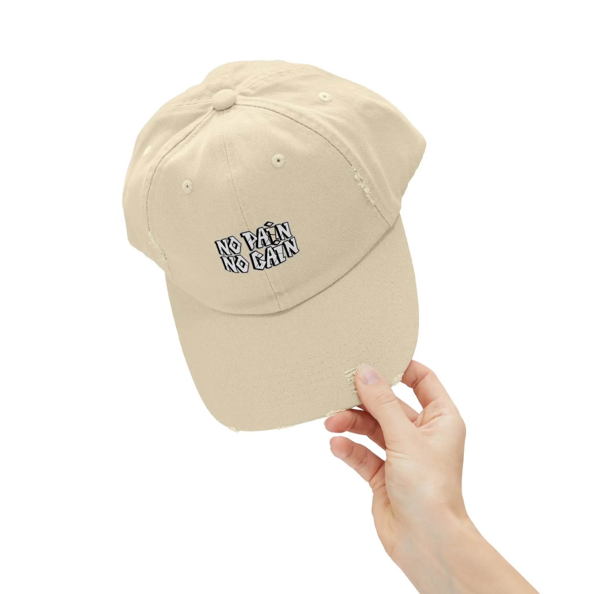 Beige MY$TOAR cap with 'NO PAIN NO GAIN' text, held by hand, luxury apparel accessory