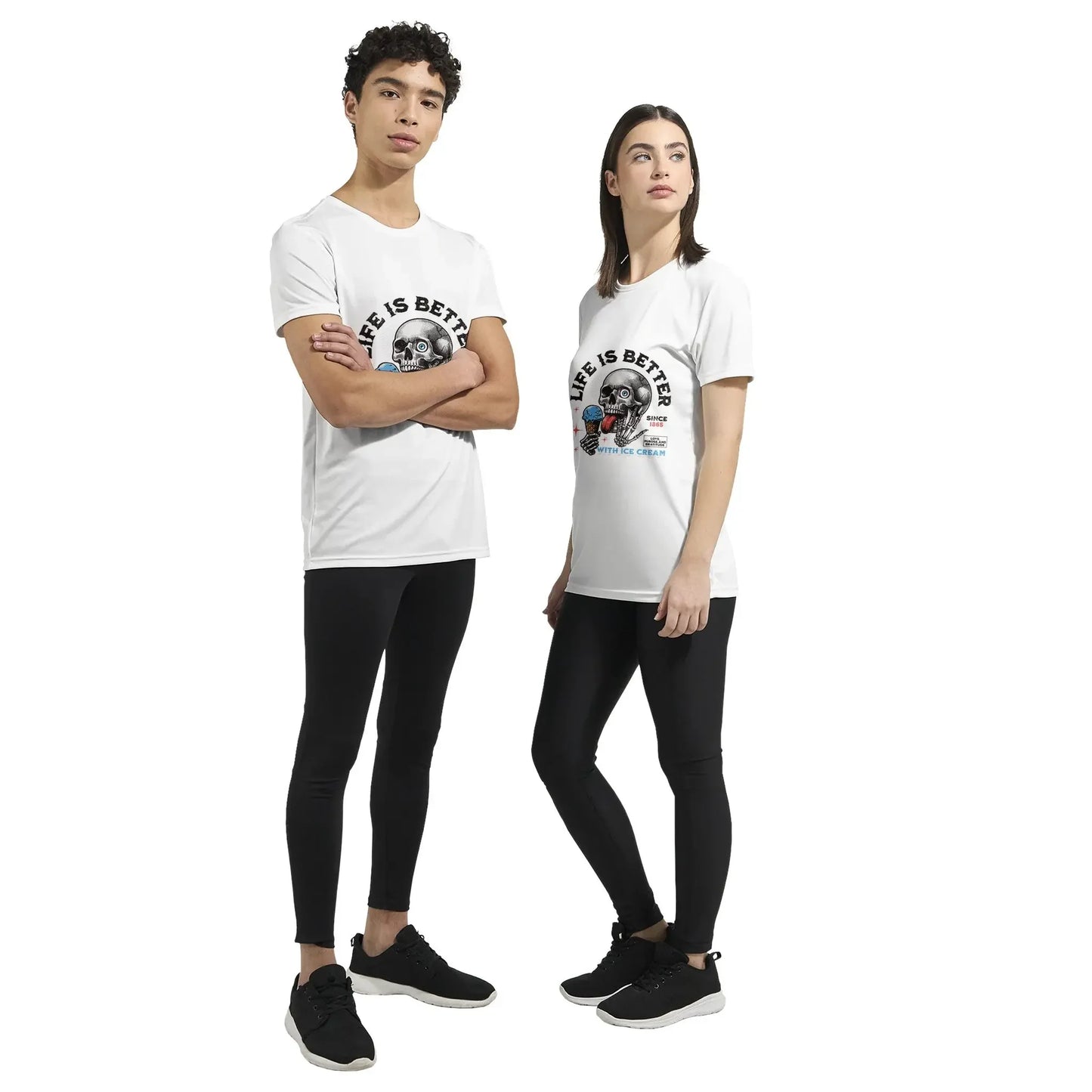 Two models wear MY$TOAR white graphic tees with skull print and black leggings, standing on white background.