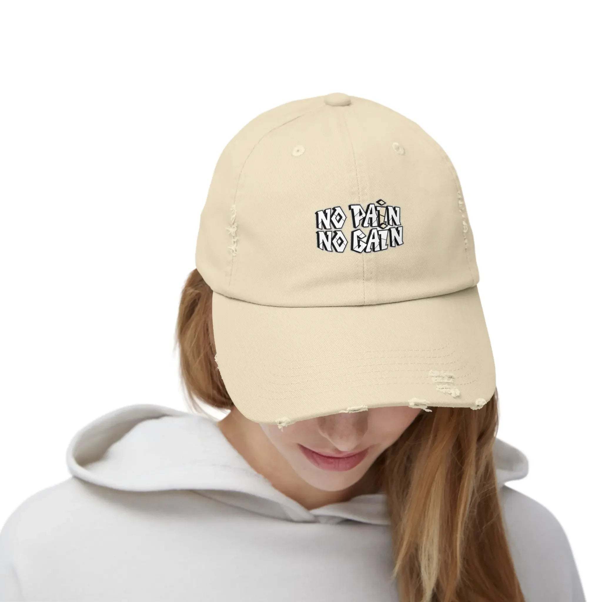 MY$TOAR beige dad hat with 'NO PAIN NO GAIN' print, worn by model in white hoodie