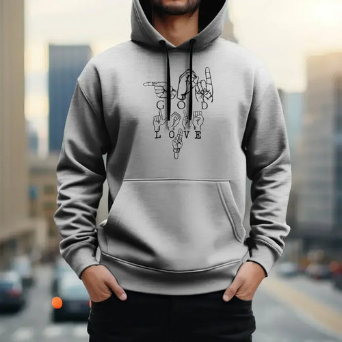 Man wearing MY$TOAR grey hoodie with 'GOD LOVE U' hand sign design, urban background.