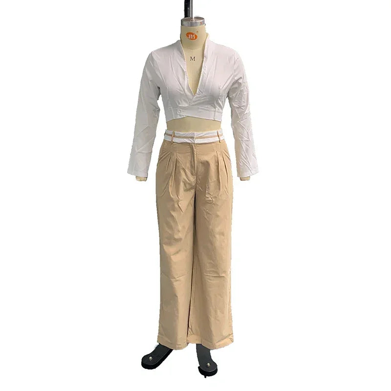 Women's two-piece set with white long sleeve crop top and beige high-waist wide-leg pants on mannequin