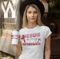 Woman wearing 'Jesus is my superhero' graphic tee, holding travel mug, outside store