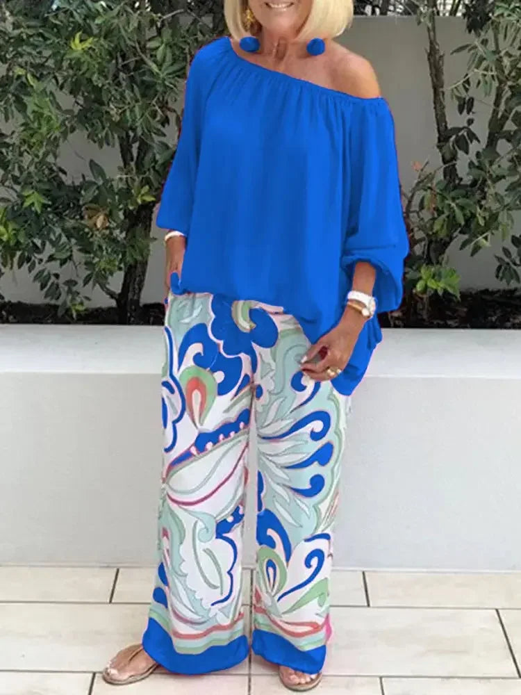 Woman wearing blue off-shoulder top and abstract print wide-leg pants, MY$TOAR fashion