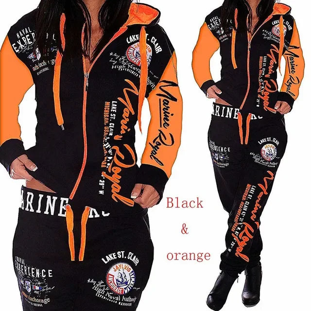 Woman wearing MY$TOAR black and orange hoodie tracksuit with bold graphic prints, luxury apparel
