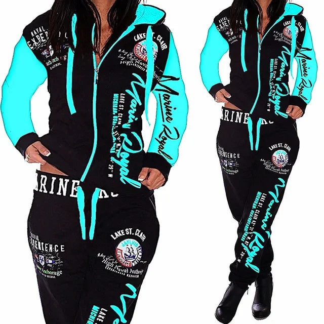 Woman wearing MY$TOAR luxury black and sky blue tracksuit with bold graphic prints